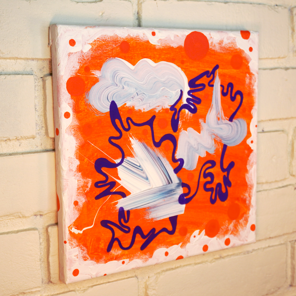 Abstract artwork with wavy lines and cloud shapes on an orange background, mounted on a brick wall.